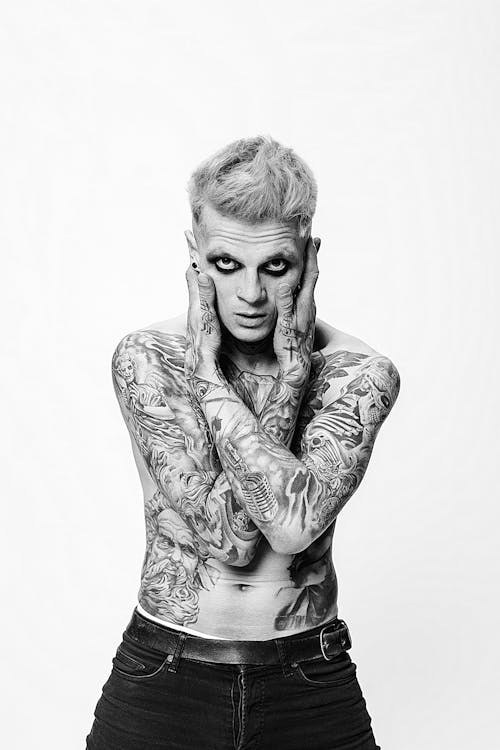 
A Grayscale of a Tattooed Man