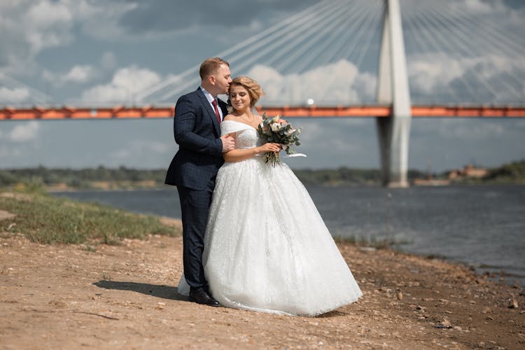 Groom Kissing The Bride's Head 