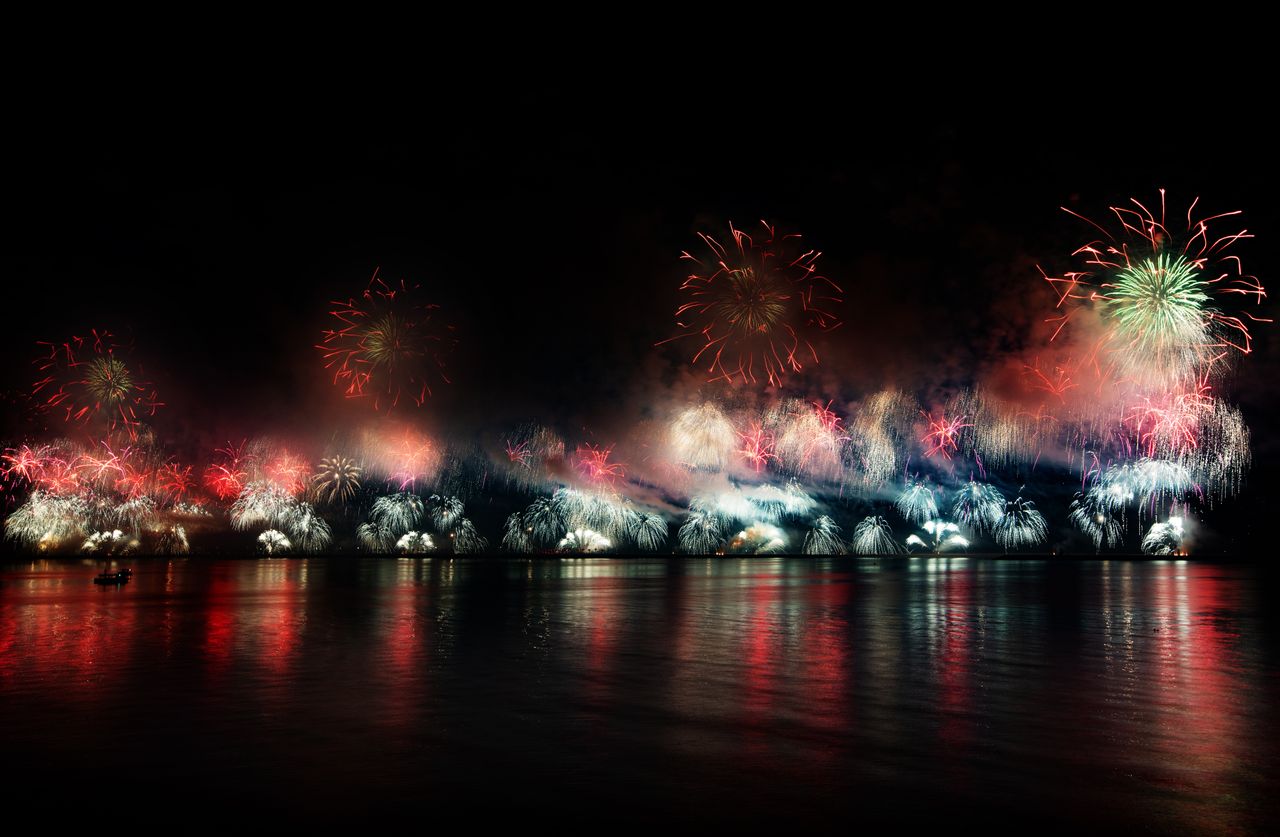 colorful fireworks reflecting over water in ras al khaimah at night ca