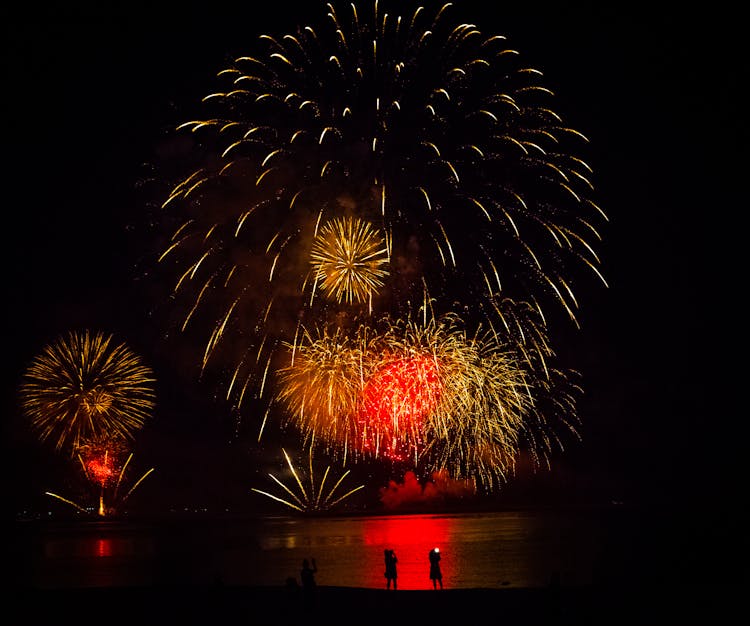 Silhouette Of People Under Fireworks Display