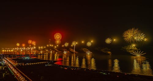 Fireworks Display Over Body of Water During Night Time