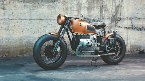 Free Orange and Black Bmw Motorcycle Before Concrete Wall Stock Photo