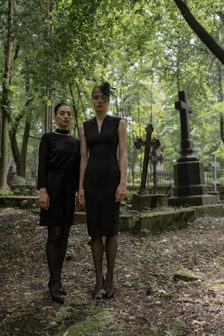 Women In Black Dresses Standing In Graveyard