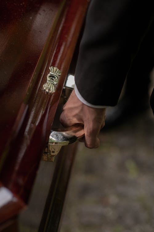 Free Person in Black Suit Jacket Carrying a Coffin Stock Photo