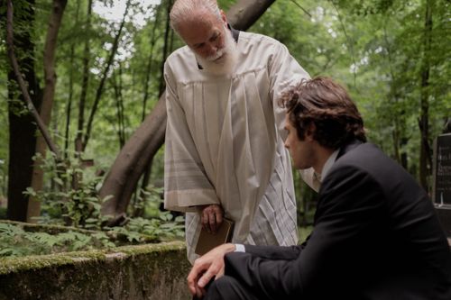Free A gentle pastoral scene of sympathy and support in a serene forest setting. Stock Photo