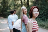 Smiling Girls in Small Group of Teenagers on Walk on Forest Footpath