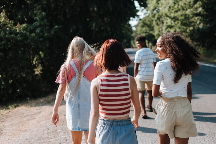 Small Group Of Teenagers Going For Walk To Forest