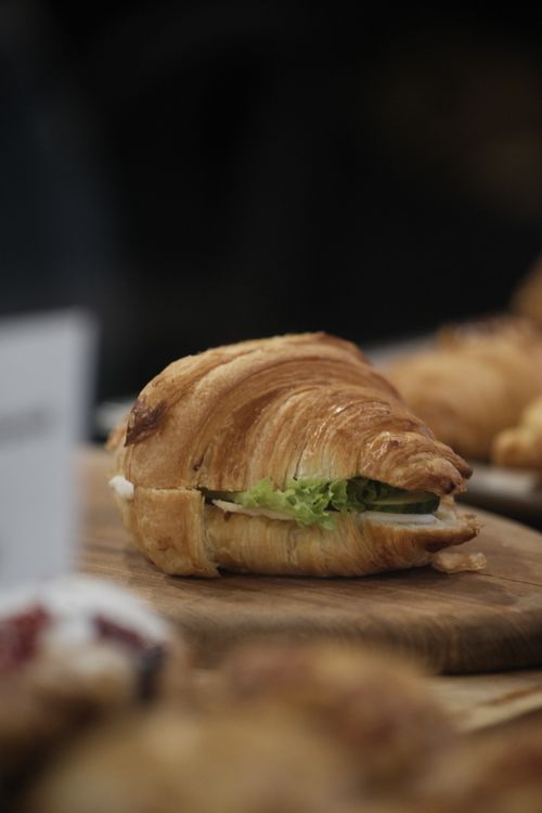 Free Delicious croissant sandwich filled with fresh lettuce, perfect for lunch or a snack. Stock Photo