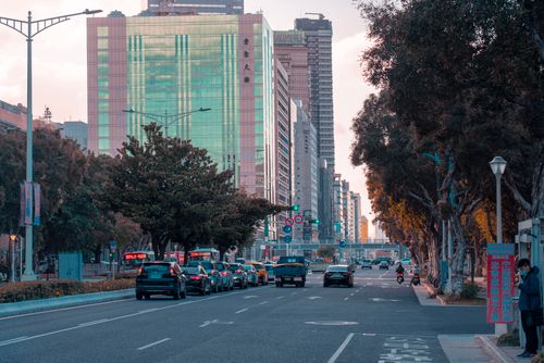 Free City street bustling with cars and skyscrapers during daytime in a modern urban setting. Stock Photo