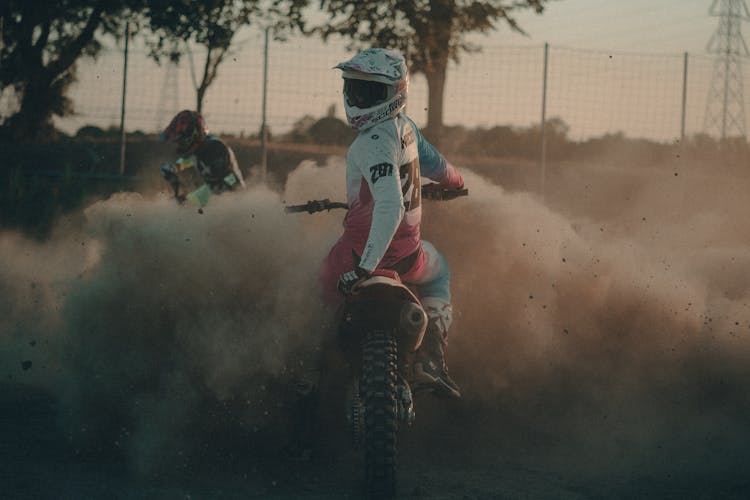 People Riding Motorbikes In Dust 