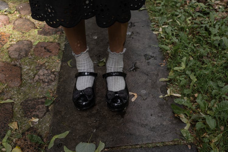 A Girl Wearing Black School Shoes With White Socks 