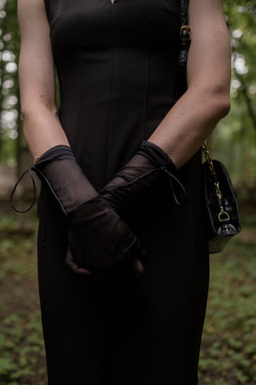 Woman in Black Dress Wearing Black Sheer Gloves