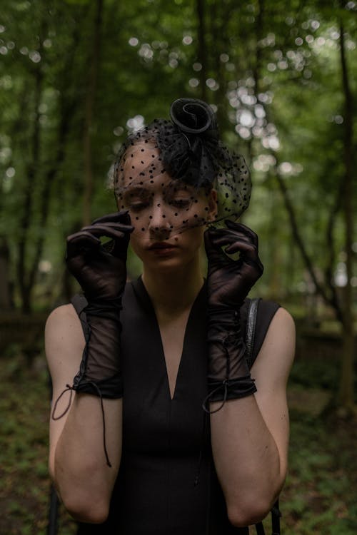 Free Mourner in a Black Toque with a Veil at the Graveyard Stock Photo