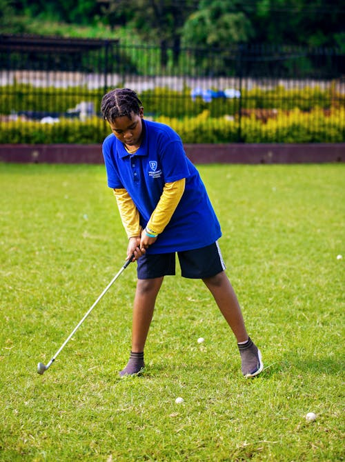 Boy in Blue Polo Shirt Playing Golf