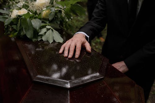 Person's Hand on the Coffin 