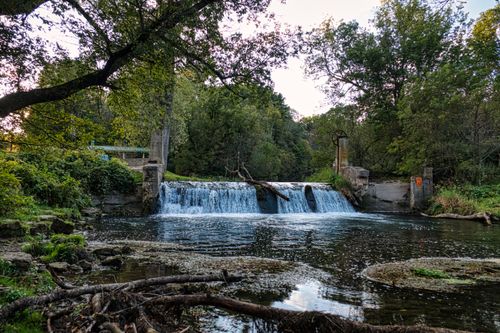 Free Beautiful small waterfall surrounded by lush greenery in Chatfield, Minnesota. Ideal for nature lovers. Stock Photo