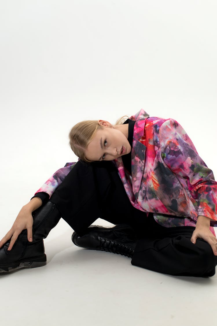 A Woman Resting Her Head On Her Knee 