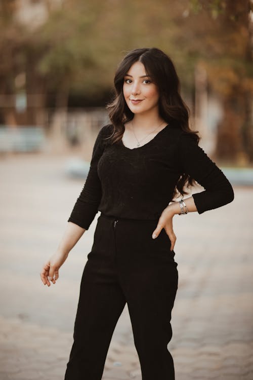 A Woman in Black Long Sleeve Shirt and Black Pants
