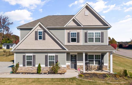 Free Bright and welcoming two-story suburban home with a classic design and manicured lawn. Stock Photo