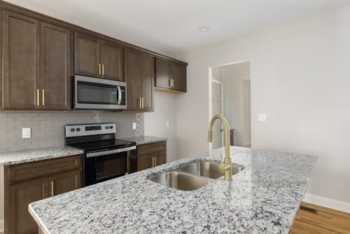 Stainless Steel Faucet on White and Black Marble Kitchen Counter