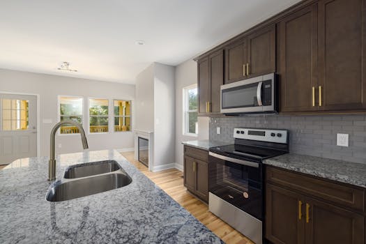 Sleek kitchen design featuring granite countertops and stainless steel appliances.