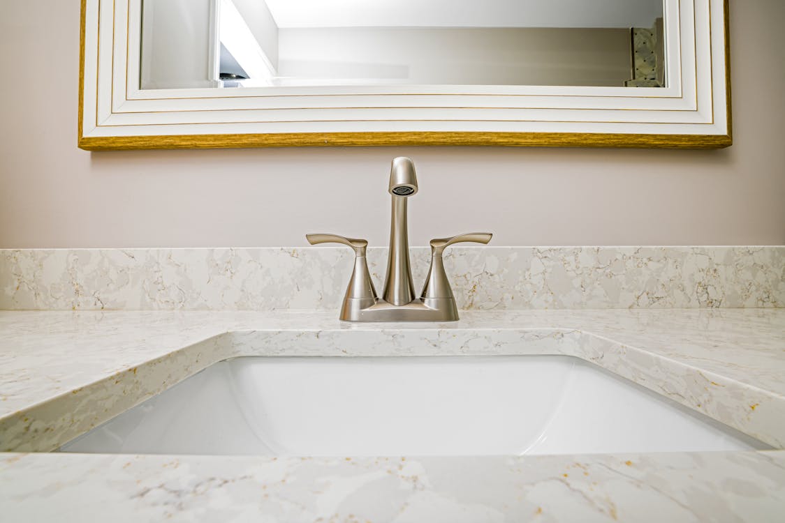 Stainless Steel Faucet on White Ceramic Sink
