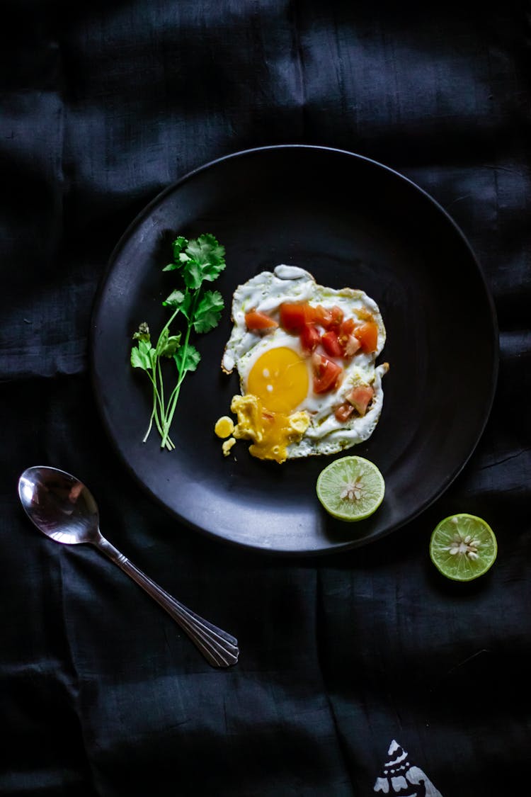 Overhead Shot Of A Sunny Side Up Egg With Chopped Tomatoes