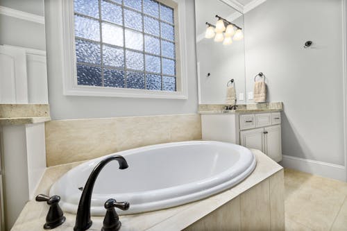 White Ceramic Bathtub With Black Faucet