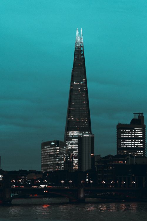Free Iconic view of The Shard in London illuminated against the twilight sky. Stock Photo