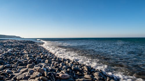 Black and Gray Rocks Near the Ocean  