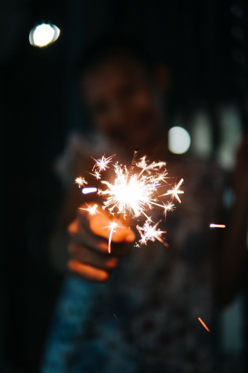 Free A lively sparkler brightens the night, capturing the essence of joy and festivity. Stock Photo