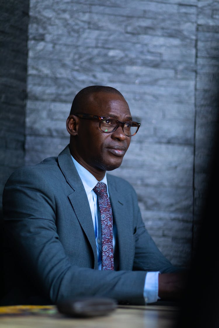 Serious Man In Glasses And Suit