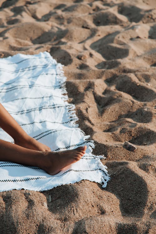 Legs of Woman on Beach Towel