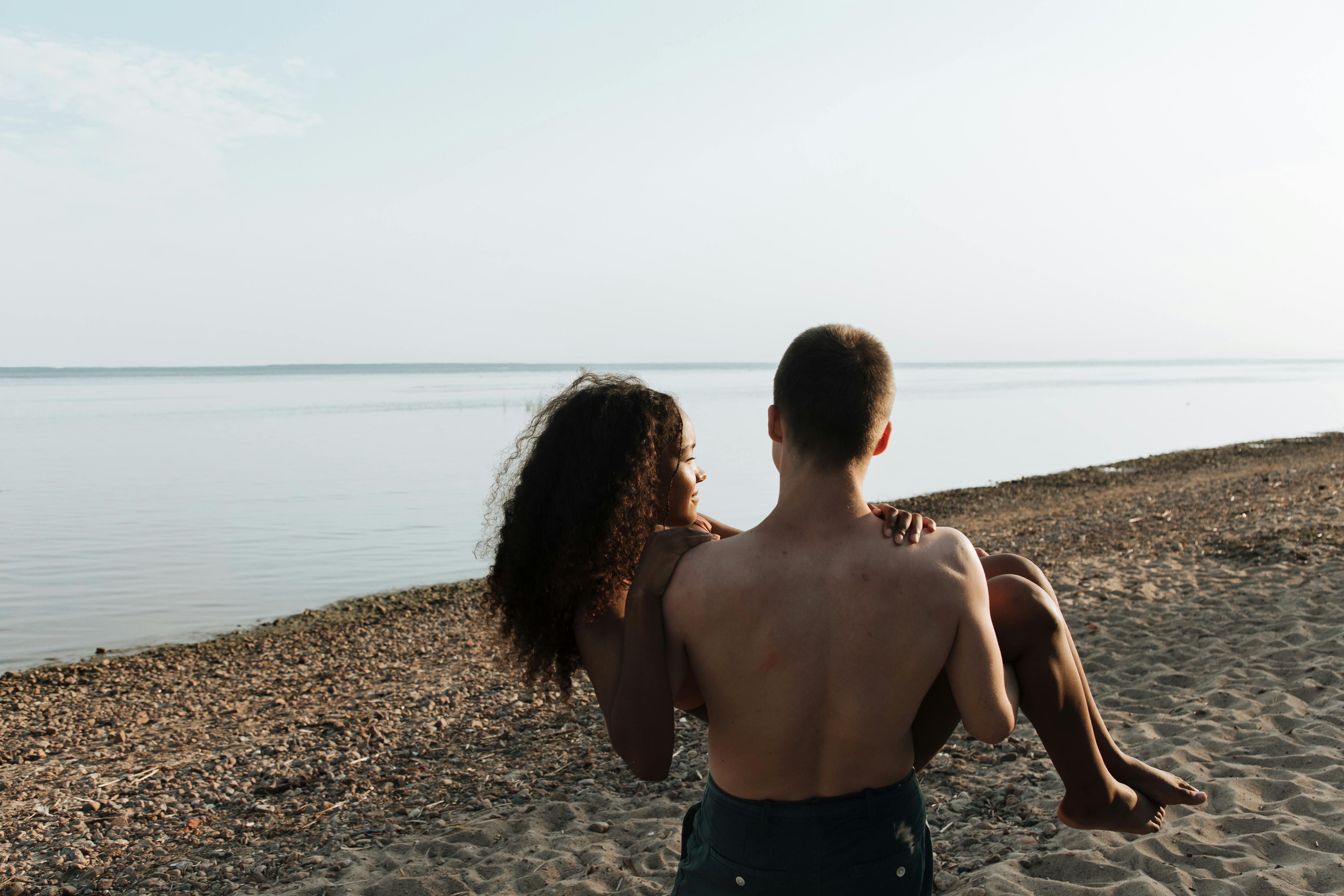 A loving couple enjoying a serene moment on a tranquil beach, perfect for romantic themes.