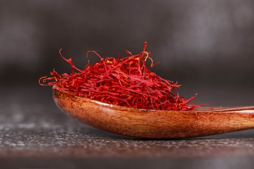 Free Red Saffron Spice on Brown Wooden Spoon  Stock Photo