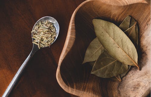 Bay Leaves in a Bowl and a Spoon with Herbs 
