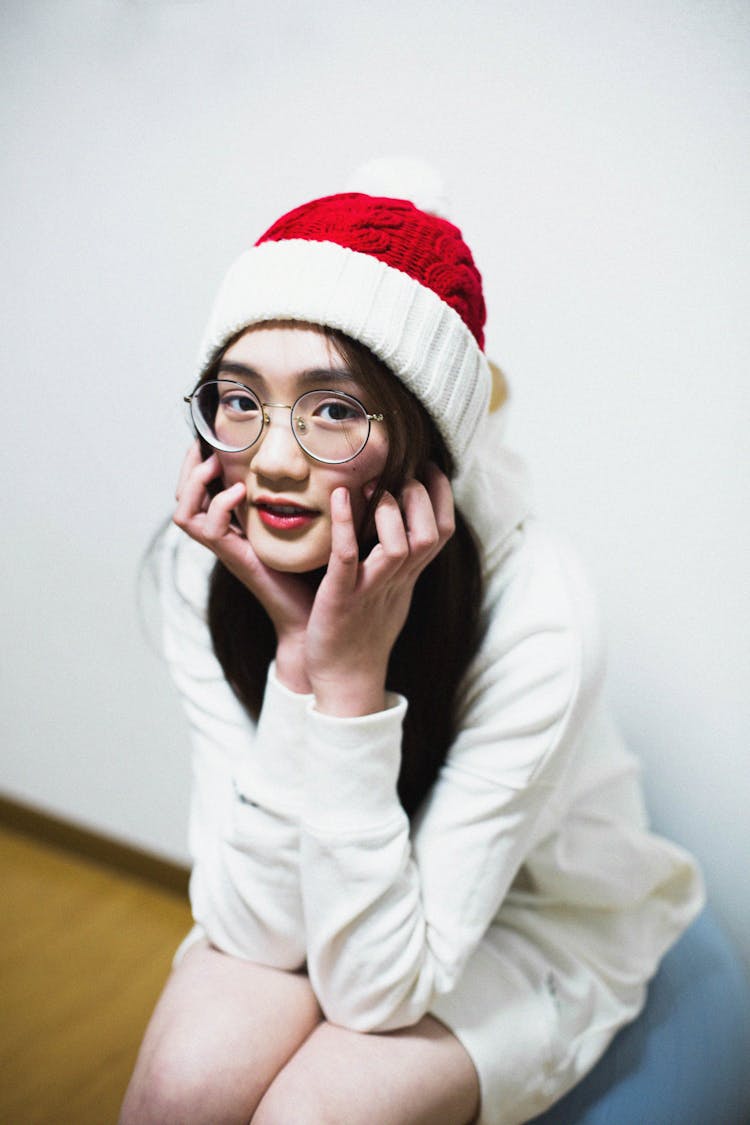 Woman In White Jacket Wearing Santa Hat 