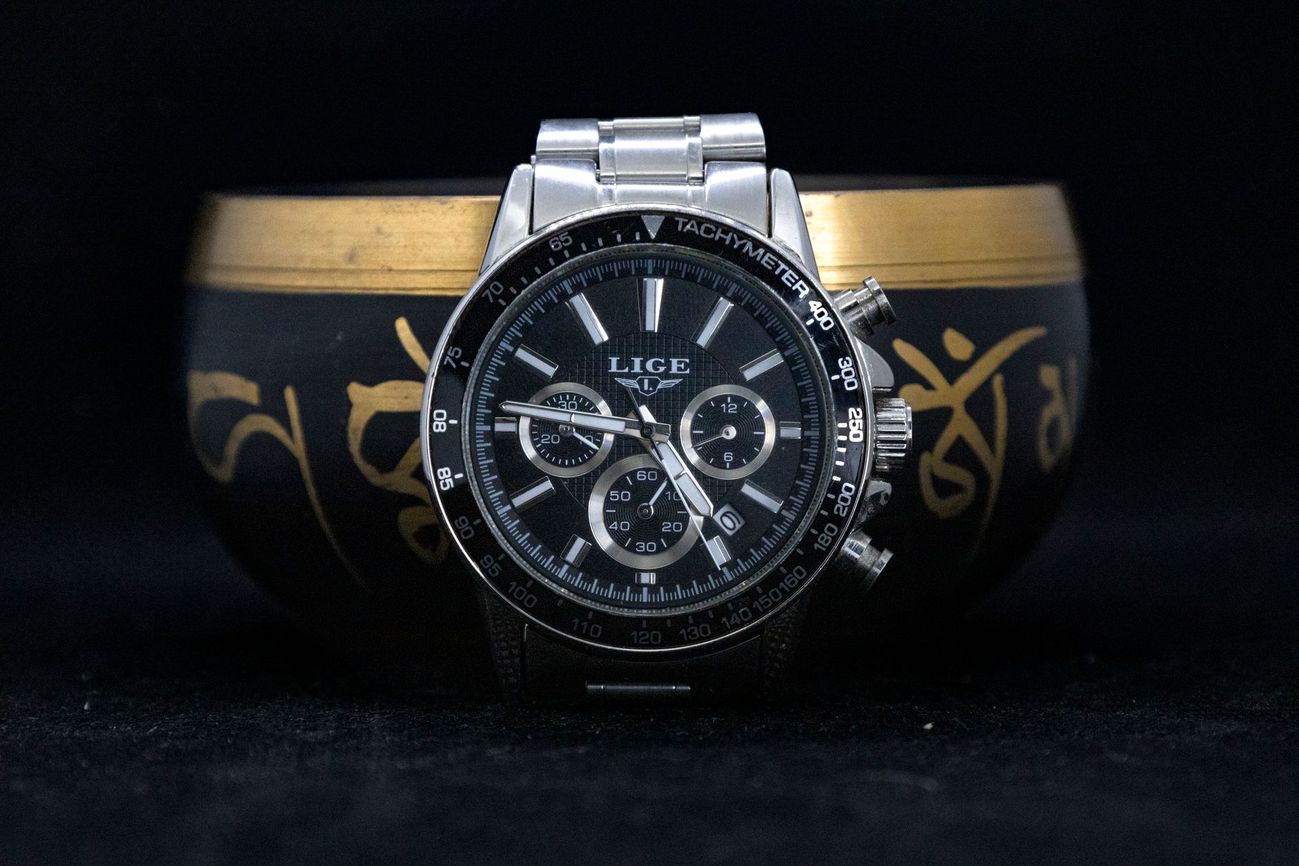 Close-up view of a stylish Lige chronograph wristwatch with a black and silver design.