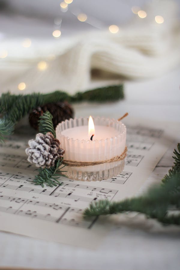 Lit Candle on the Paper with Notation