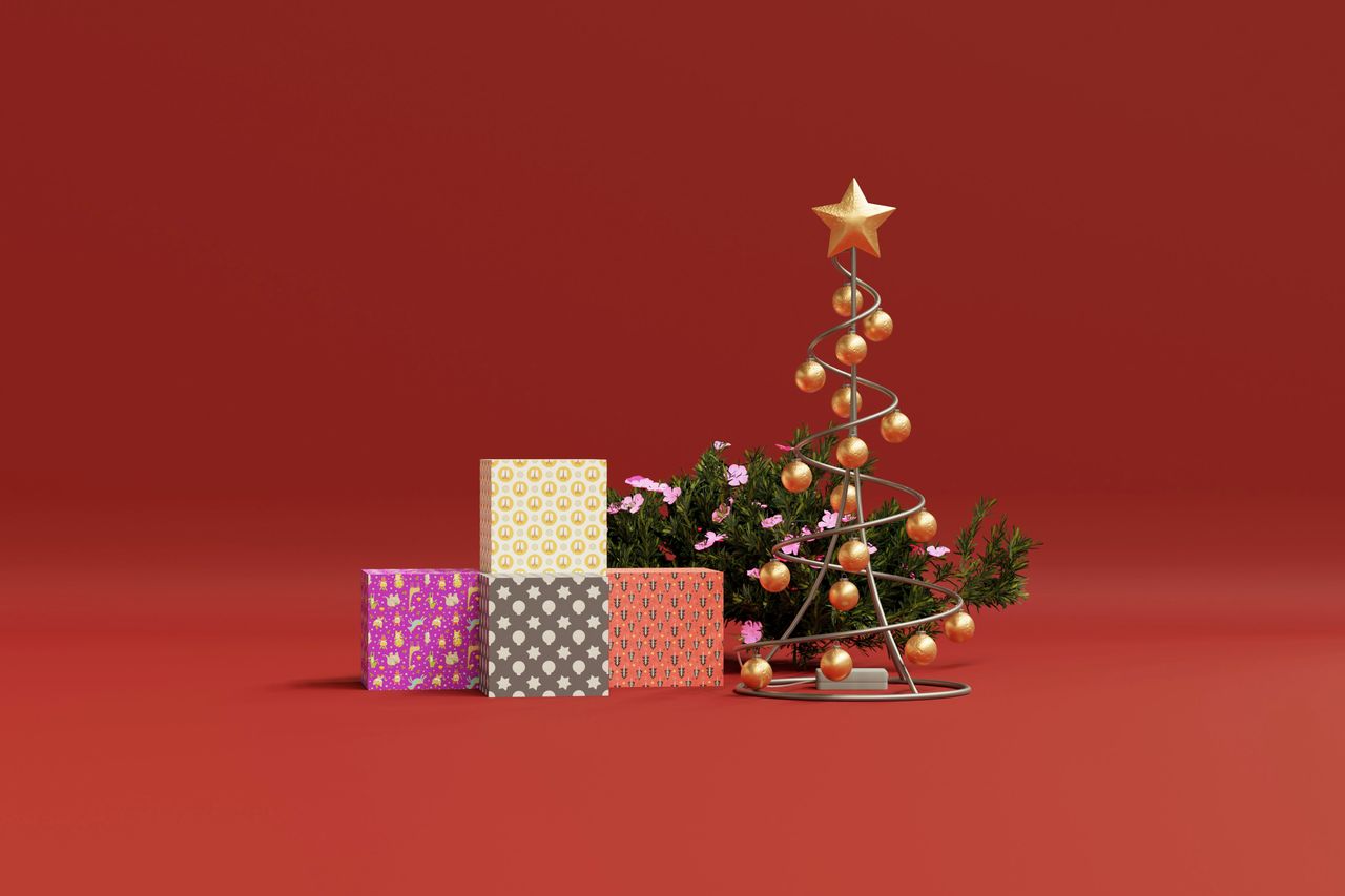 minimalist christmas scene with gifts and a modern wire tree on a red