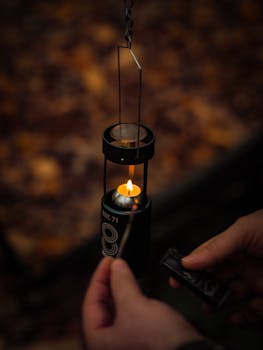 Warm ambient lighting with hands lighting a lantern outdoors in Turkey.