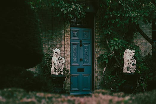 Blue Wooden Door With White and Black Cat Figurine