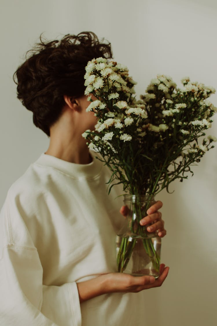 Person Holding Bouquet In Vase