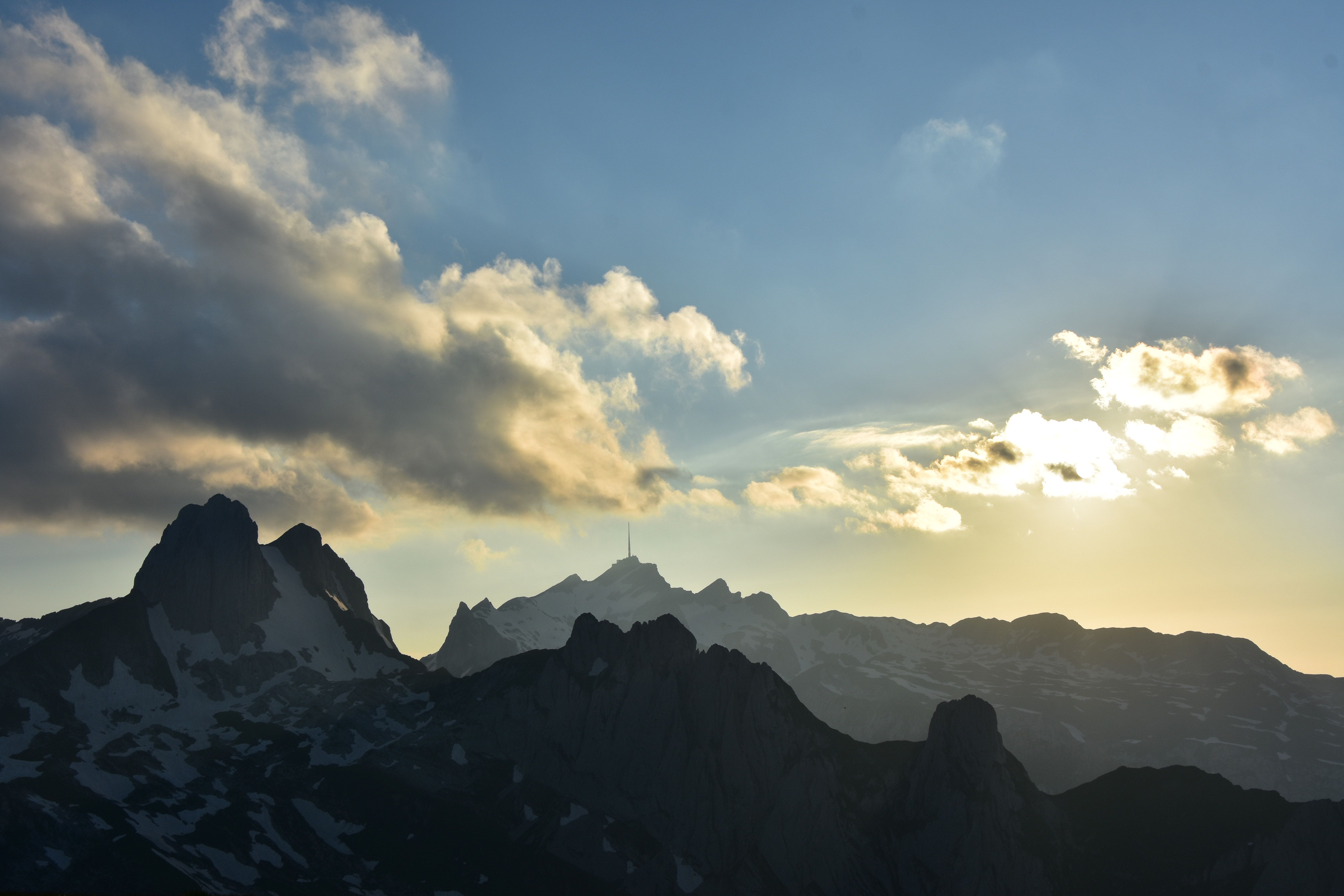Majestic sunset view over the Swiss mountains showcasing vibrant sky and rugged peaks.