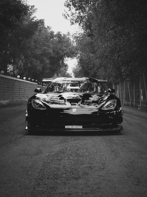 Free Grayscale Photo of a Sports Car Parked on the Road Stock Photo