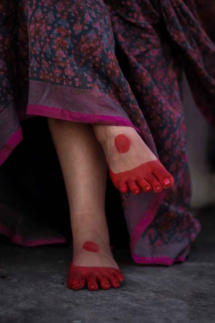 Woman With Red Dye On Her Feet