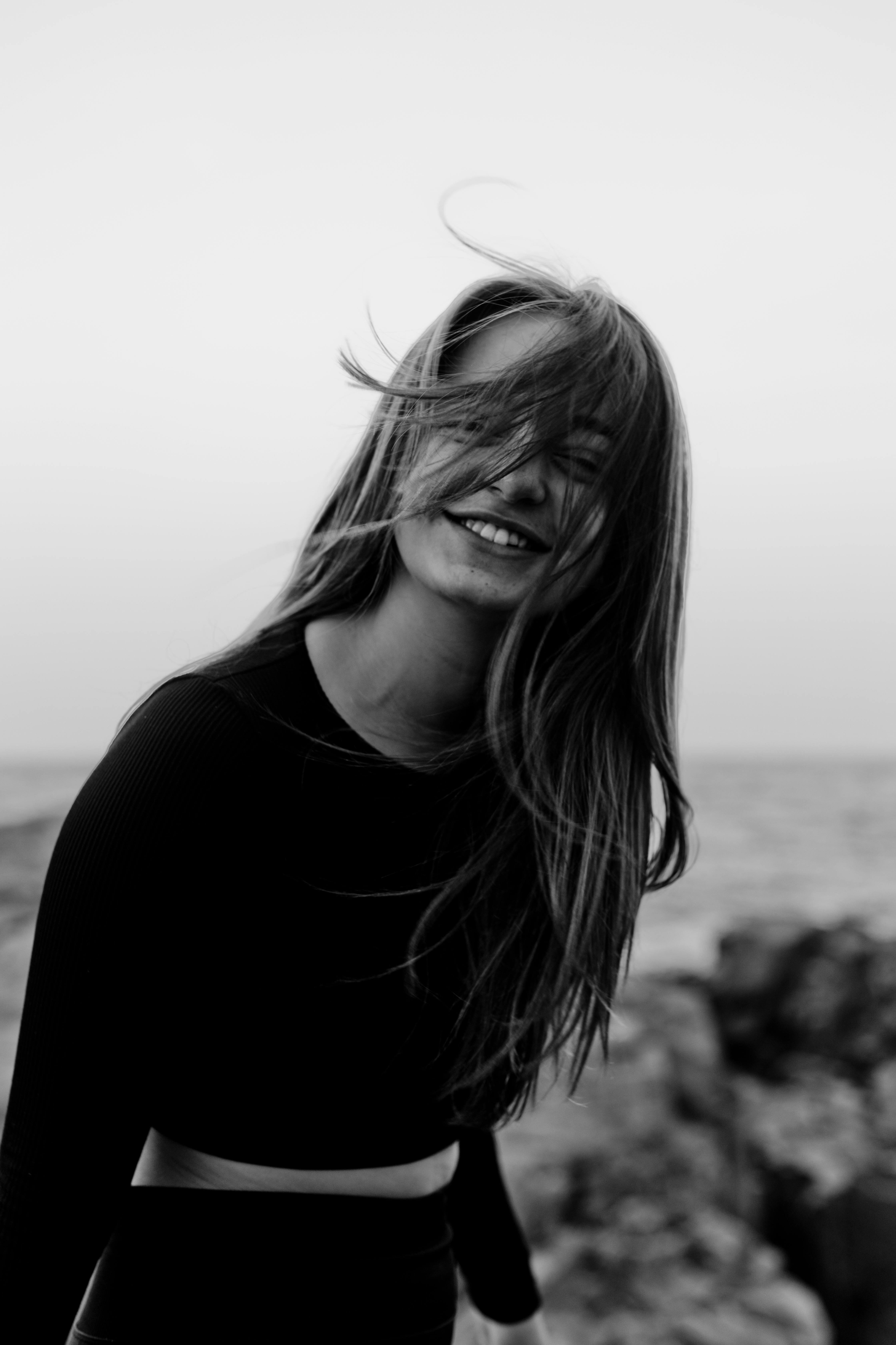 A Black and White Portrait of Smiling Female With Hair on Her Face · Free  Stock Photo