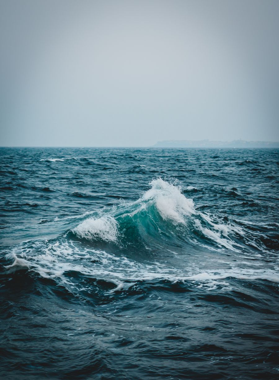 A single wave folding over in open water — photo by Super Straho on Pexels