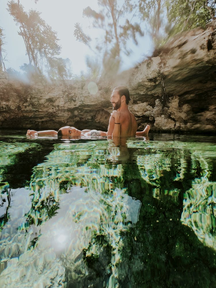 A Couple Swimming In A Lake