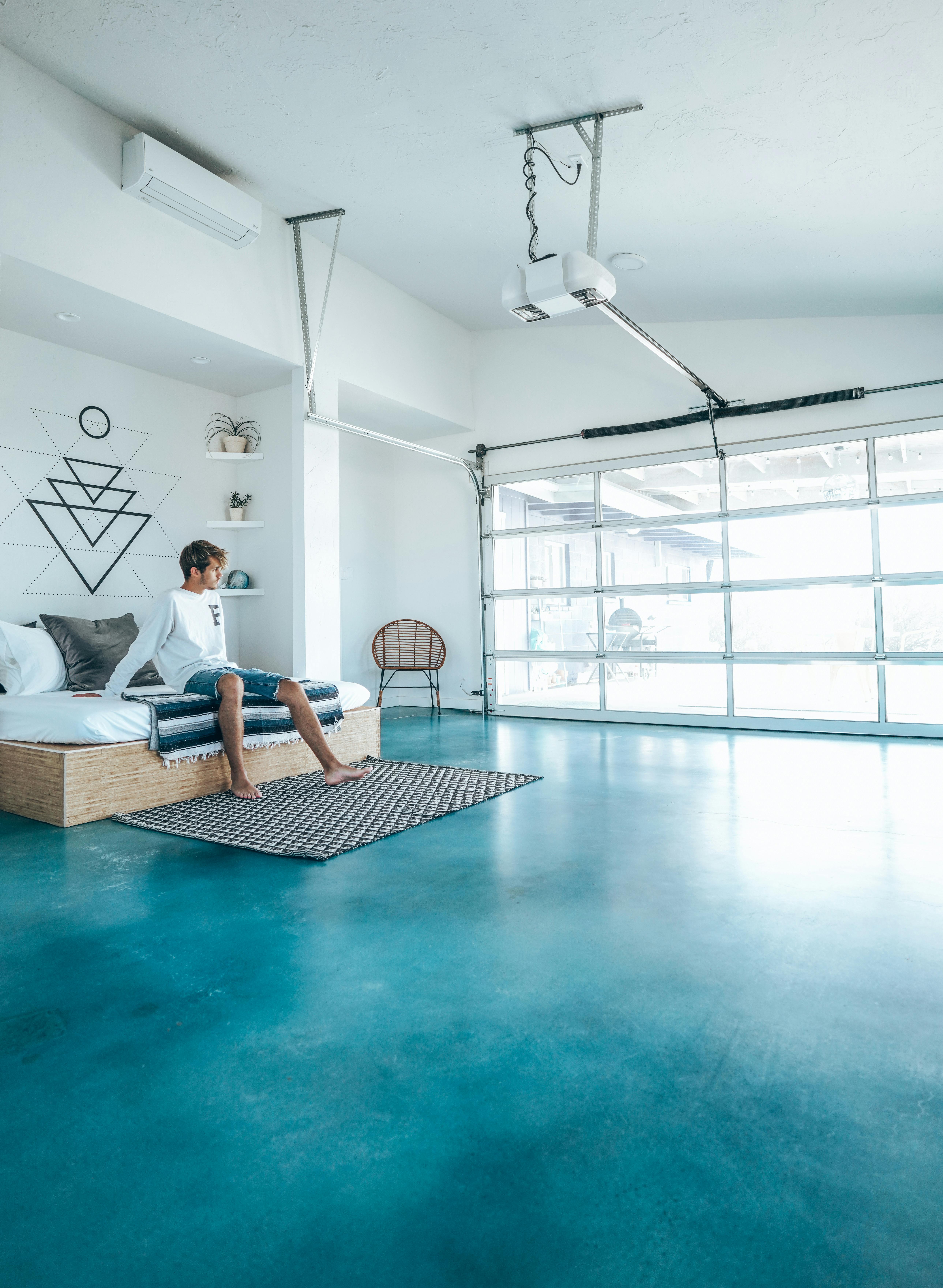 man in bedroom with blue floor